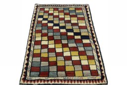 Surface texture of 2000s Persian Gabbeh rug with natural Wool and intricate pattern