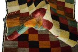 Corner detail of 2000s Persian Gabbeh rug showing border pattern and Wool pile