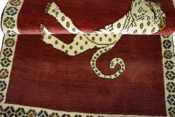 Full view of 2000s Persian Gabbeh rug from Iran / Persia, 127 × 83 cm in Red tones