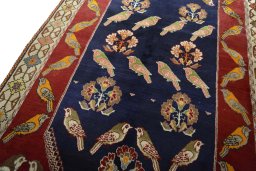 Backside of handmade 2000s Persian Gabbeh rug showing knot structure and weave density