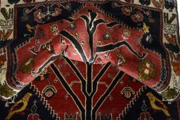 Corner detail of 2000s Persian Gabbeh rug showing border pattern and Wool pile