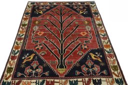 Surface texture of 2000s Persian Gabbeh rug with natural Wool and intricate pattern