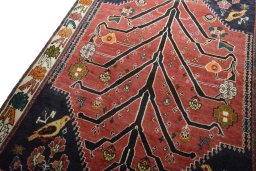 Backside of handmade 2000s Persian Gabbeh rug showing knot structure and weave density