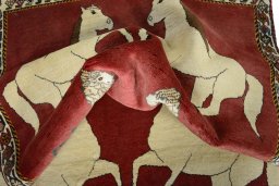 Corner detail of 2000s Persian Gabbeh rug showing border pattern and Wool pile