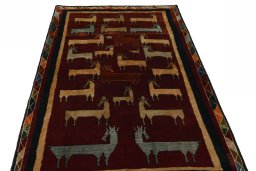 Surface texture of 2000s Persian Gabbeh rug with natural Wool and intricate pattern