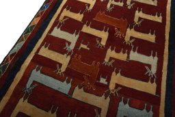 Backside of handmade 2000s Persian Gabbeh rug showing knot structure and weave density