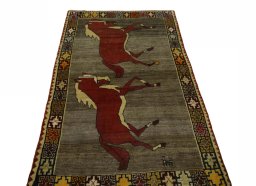 Surface texture of 2000s Persian Gabbeh rug with natural Wool and intricate pattern