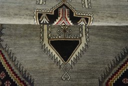 Corner detail of 2000s Persian Gabbeh rug showing border pattern and Wool pile