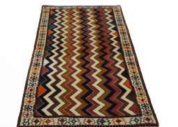 Surface texture of 2000s Persian Gabbeh rug with natural Wool and intricate pattern