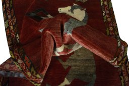 Corner detail of 2000s Persian Gabbeh rug showing border pattern and Wool pile