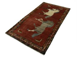 Corner detail of 2000s Persian Gabbeh rug showing border pattern and Wool pile