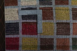 Corner detail of 2000s Persian Gabbeh rug showing border pattern and Wool pile