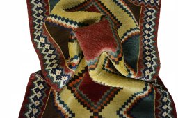 Corner detail of 2000s Persian Gabbeh rug showing border pattern and Wool pile