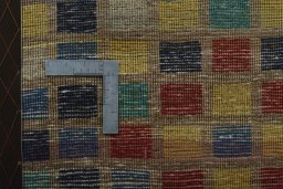 Corner detail of 2000s Persian Gabbeh rug showing border pattern and Wool pile