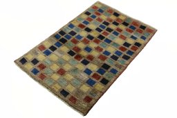 Corner detail of 2000s Persian Gabbeh rug showing border pattern and Wool pile