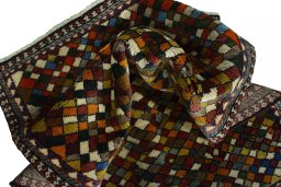 Corner detail of 2000s Persian Gabbeh rug showing border pattern and Wool pile