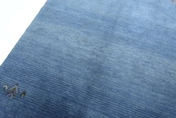 Backside of handmade New Persian Gabbeh rug showing knot structure and weave density