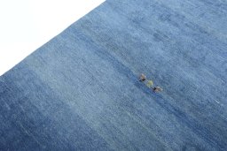 Backside of handmade New Persian Gabbeh rug showing knot structure and weave density