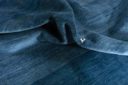 Corner detail of New Persian Gabbeh rug showing border pattern and Wool pile