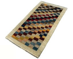 Corner detail of 2000s Persian Gabbeh rug showing border pattern and Wool pile