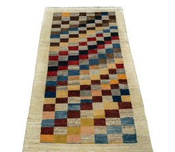 Surface texture of 2000s Persian Gabbeh rug with natural Wool and intricate pattern