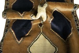 Corner detail of 2000s Persian Gabbeh rug showing border pattern and Wool pile