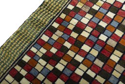 Backside of handmade 2000s Persian Gabbeh rug showing knot structure and weave density