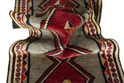 Corner detail of 2000s Persian Gabbeh rug showing border pattern and Wool pile