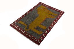 Corner detail of 2000s Persian Gabbeh rug showing border pattern and Wool pile