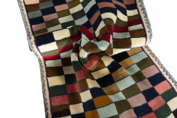 Corner detail of 2000s Persian Gabbeh rug showing border pattern and Wool pile