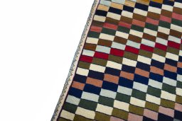 Backside of handmade 2000s Persian Gabbeh rug showing knot structure and weave density
