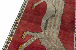 Backside of handmade 2000s Persian Gabbeh rug showing knot structure and weave density