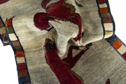 Corner detail of 2000s Persian Gabbeh rug showing border pattern and Wool pile