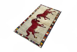 Corner detail of 2000s Persian Gabbeh rug showing border pattern and Wool pile