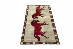 Surface texture of 2000s Persian Gabbeh rug with natural Wool and intricate pattern