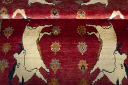 Full view of 2000s Persian Gabbeh rug from Iran / Persia, 180 × 130 cm in Red tones