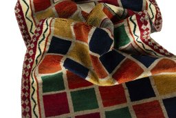Corner detail of 2000s Persian Gabbeh rug showing border pattern and Wool pile