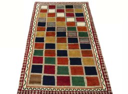 Surface texture of 2000s Persian Gabbeh rug with natural Wool and intricate pattern