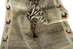 Corner detail of 2000s Persian Gabbeh rug showing border pattern and Wool pile
