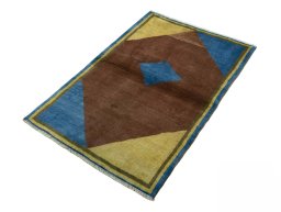 Corner detail of 2000s Persian Gabbeh rug showing border pattern and Wool pile
