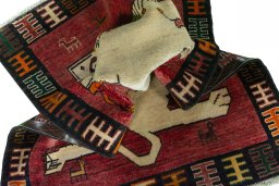 Corner detail of 2000s Persian Gabbeh rug showing border pattern and Wool pile