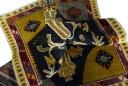 Corner detail of 2000s Persian Gabbeh rug showing border pattern and Wool pile