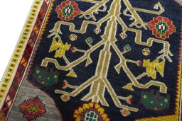 Backside of handmade 2000s Persian Gabbeh rug showing knot structure and weave density