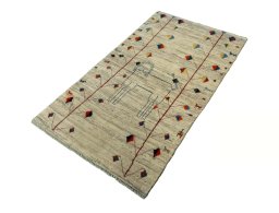 Corner detail of 2000s Persian Gabbeh rug showing border pattern and Wool pile