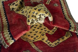 Corner detail of 2000s Persian Gabbeh rug showing border pattern and Wool pile