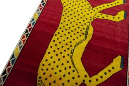 Backside of handmade 2000s Persian Gabbeh rug showing knot structure and weave density