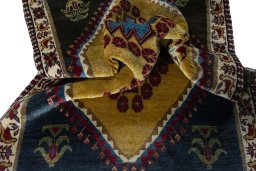 Corner detail of 2000s Persian Gabbeh rug showing border pattern and Wool pile