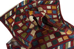 Corner detail of 2000s Persian Gabbeh rug showing border pattern and Wool pile
