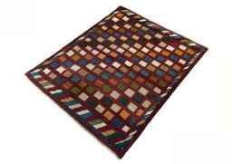 Corner detail of 2000s Persian Gabbeh rug showing border pattern and Wool pile