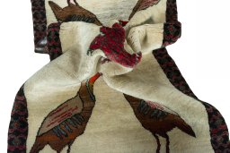 Corner detail of 2000s Persian Gabbeh rug showing border pattern and Wool pile